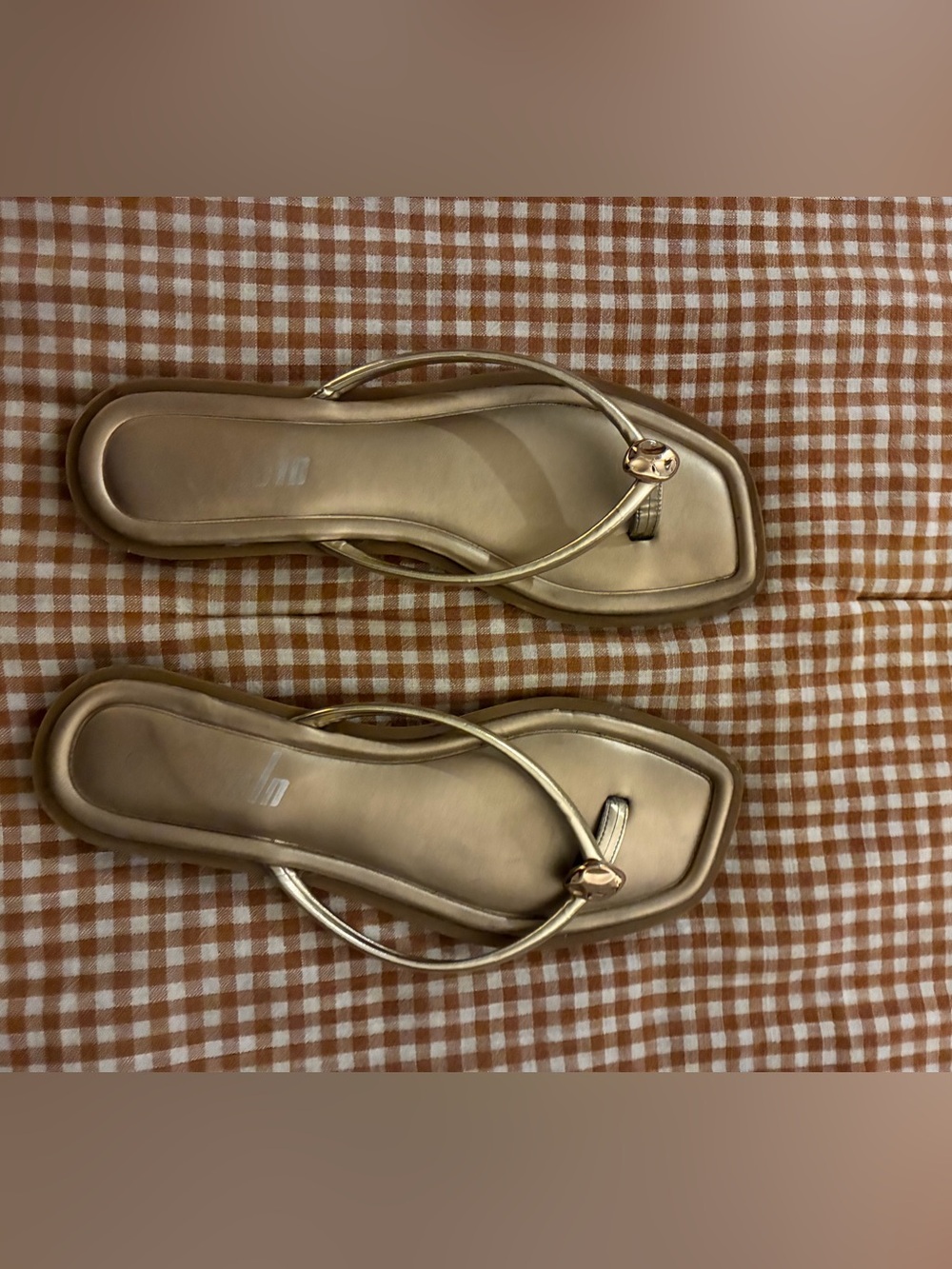 Gold metallic flip flops